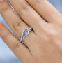tanzanite and white zircon ring in rhodium over sterling silver worn on a hand