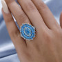 neon blue apatite cluster ring in rhodium over sterling silver worn on a hand