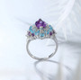 side view of amethyst blue topaz and zircon halo cluster ring in rhodium over sterling silver