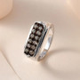 champagne diamond gents wedding ring in rhodium over sterling silver shown in a lifestyle photo