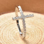 moissanite cross ring in rhodium over sterling silver shown in a lifestyle photo