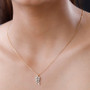 white zircon leaf pendant necklace in 18k yellow gold over sterling silver worn around the neck