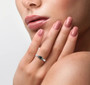 black diamond and white diamond trilogy ring in rhodium over sterling silver worn on a hand