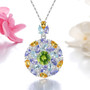 peridot tanzanite and citrine topaz and zircon pendant necklace in rhodium over sterling silver shown in a lifestyle photo
