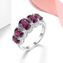 rhodolite garnet and white zircon five stone ring in rhodium over sterling silver shown in a lifestyle photo