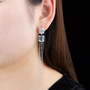 sky blue topaz and zircon mismatched dangle earrings in rhodium over sterling silver worn on the ear