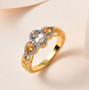 turkizite orange sapphire and white zircon ring in 18k yellow gold over sterling silver shown in a lifestyle photo
