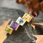 square cut multi gemstone band ring in 18k yellow gold over sterling silver shown in a lifestyle photo