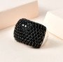 black spinel cluster wide band ring in black and white rhodium over sterling silver shown in a lifestyle photo