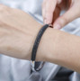 black spinel cluster bangle bracelet in rhodium over sterling silver worn on a wrist