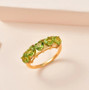 peridot heart five stone band ring in 18k yellow gold over sterling silver worn on a hand