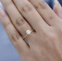 round womens natural diamond wedding ring in 18k yellow gold worn on a hand