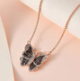 champagne and white diamond butterfly necklace in 18k rose gold over sterling silver shown in a lifestyle photo