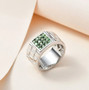 tsavorite garnet gents ring in black and white rhodium over sterling silver shown in a lifestyle photo