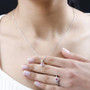 pink tourmaline and zircon ring and necklace jewelry set in 18k yellow gold and rhodium over sterling silver worn around the neck