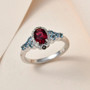 rubellite tourmaline aquamarine and brown zircon ring in rhodium over sterling silver shown in a lifestyle photo