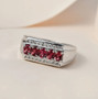 rubellite tourmaline and moissanite gents ring in rhodium over sterling silver shown in a lifestyle photo