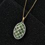 tsavorite garnet and moissanite pendant necklace in 18k yellow gold over sterling silver shown in a lifestyle photo