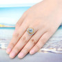 sky blue topaz and citrine halo ring in rhodium over sterling silver worn on a hand