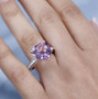 rose de france amethyst and moissanite heart ring in 18k rose gold over sterling silver worn on a hand