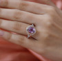 kunzite and white zircon ring in 18k rose gold over sterling silver worn on a hand