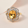 heliodor and white zircon double halo ring in 18k yellow gold over sterling silver shown in a lifestyle photo