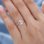 morganite and zircon halo wedding ring in 18k rose gold over sterling silver worn on a hand