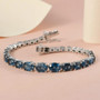 london blue topaz graduating tennis bracelet in rhodium over sterling silver shown in a lifestyle photo