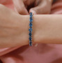 london blue topaz graduating tennis bracelet in rhodium over sterling silver worn on a wrist