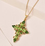 peridot and chrome diopside cross pendant necklace in 18k yellow gold over sterling silver shown in a lifestyle photo