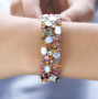 ethiopian opal and multi color tourmaline bracelet in rhodium over sterling silver worn on a wrist