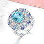 sky blue topaz ethiopian opal tanzanite and zircon cluster ring in rhodium over sterling silver shown in a lifestyle photo