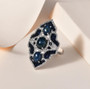 blue star sapphire sapphire and zircon ring in rhodium over sterling silver shown in a lifestyle photo