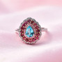 close up of blue apatite pink sapphire rubellite tourmaline and moissanite halo ring in 18k rose gold and rhodium over sterling silver