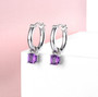 amethyst charm hoop earrings in rhodium over sterling silver shown in a lifestyle photo