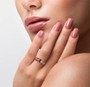 rubellite tourmaline and white zircon ring in 18k yellow gold over sterling silver worn on a hand