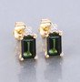 green tourmaline and diamond earrings in 14k yellow gold shown in a lifestyle photo