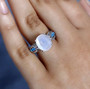 rainbow moonstone neon apatite and zircon ring in rhodium over sterling silver worn on a hand