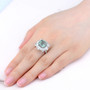 green fluorite and white zircon halo ring in rhodium over sterling silver worn on a hand