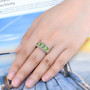 chrome diopside and peridot band ring in rhodium over sterling silver worn on a hand
