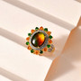 ammolite chrome diopside fire opal and zircon cluster ring in 18k yellow gold over sterling silver shown in a lifestyle photo