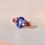 tanzanite and pink tourmaline three stone ring in 18k rose gold over sterling silver shown in a lifestyle photo