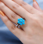 turquoise and black spinel cluster ring in black and white rhodium over sterling silver worn on a hand