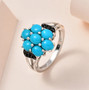 turquoise and black spinel cluster ring in black and white rhodium over sterling silver shown in a lifestyle photo
