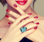 turquoise and black spinel cluster ring in 18k yellow gold and black and white rhodium over sterling silver worn on a hand