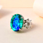 blue and green quartz triplet and white zircon statement ring in rhodium over sterling silver shown in a lifestyle photo