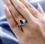 moldavite and white zircon ring in rhodium over sterling silver worn on a hand