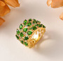 chrome diopside and zircon openwork feather ring in 18k yellow gold over sterling silver shown in a lifestyle photo