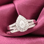 pear and round diamond halo two ring bridal set in 14k white gold shown in a lifestyle photo