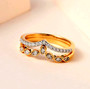 round diamond chevron stackable ring set in 18k yellow gold shown in a lifestyle photo